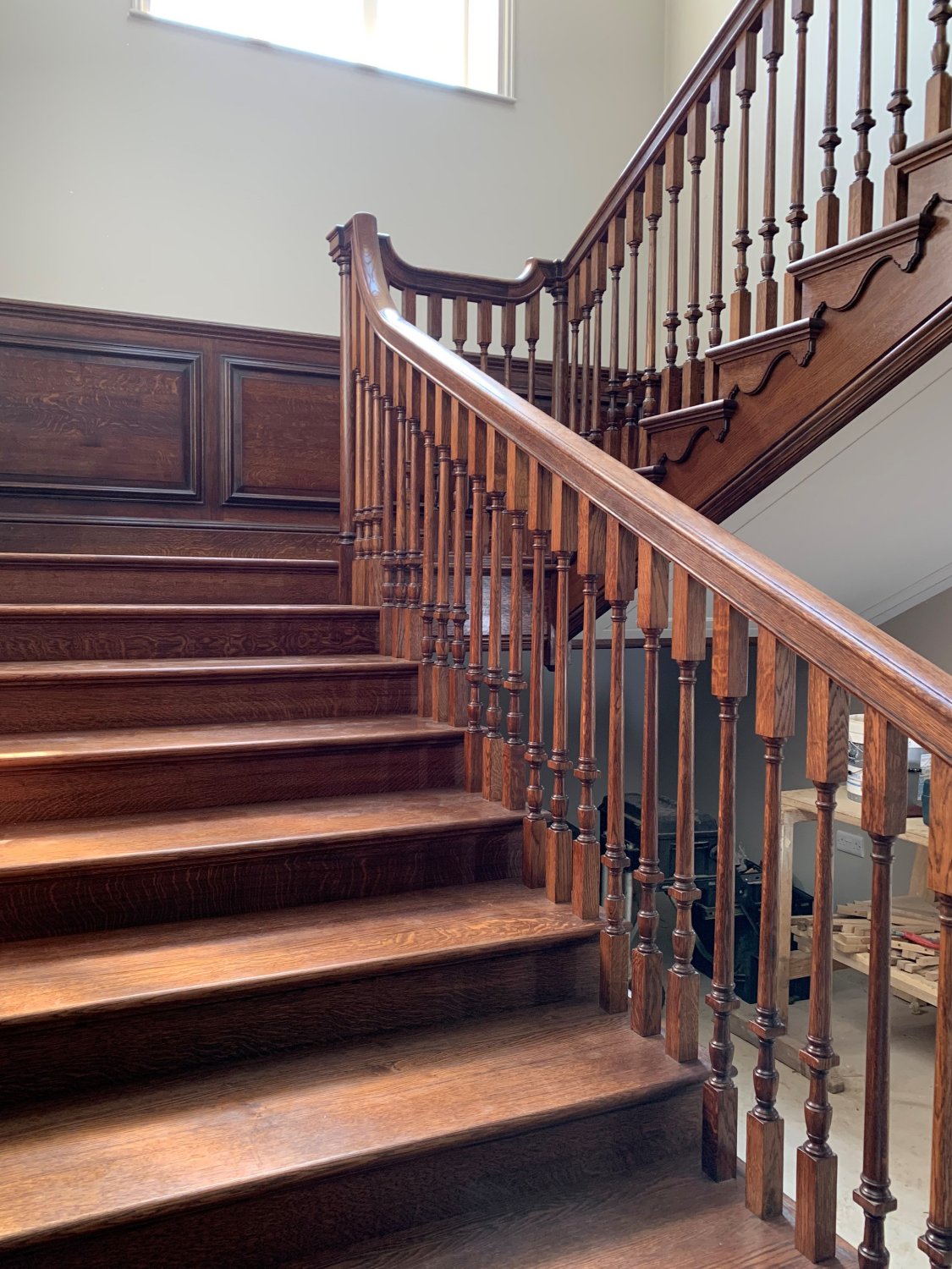 The gentle rise of the solid oak staircase