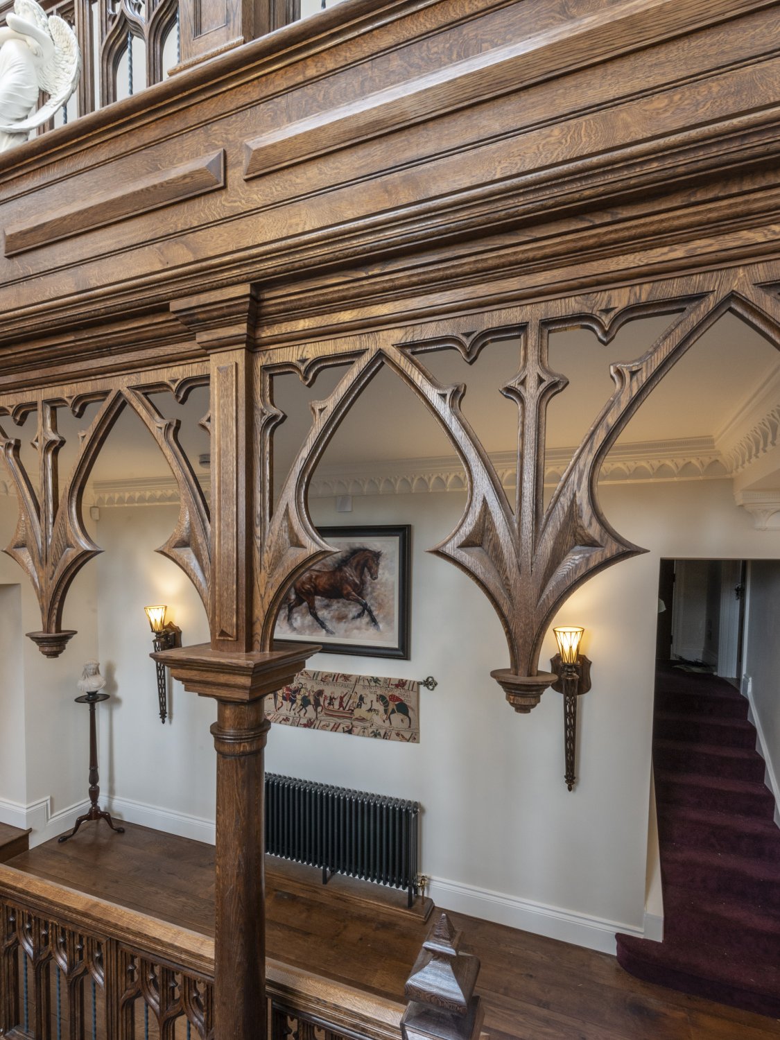 Fine Gothic tracery, decorates the gallery landing